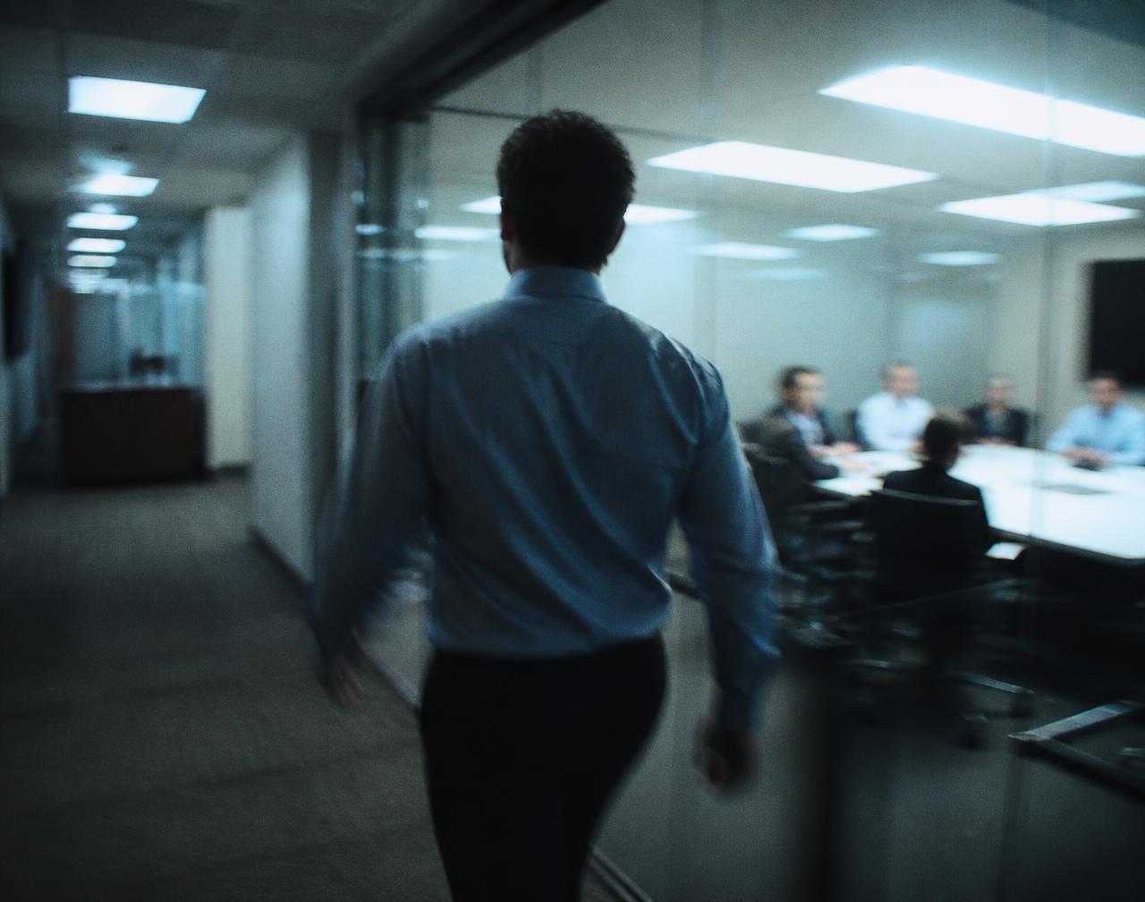 A person walking out of a meeting mid-sentence